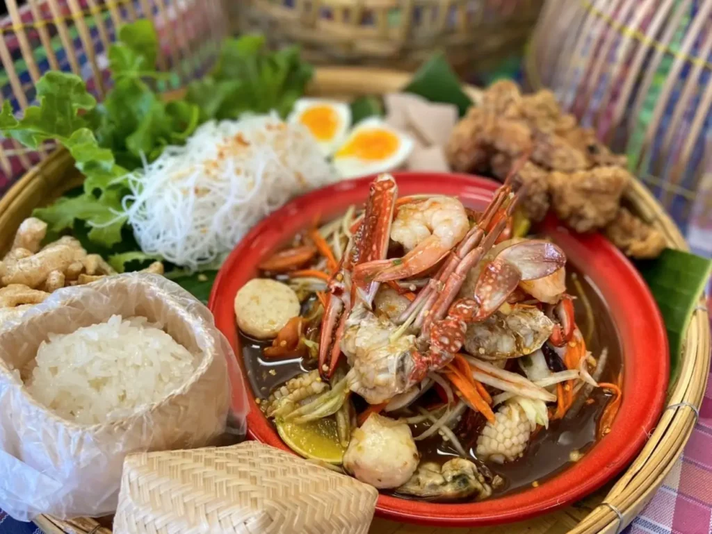 a bowl of thai food with rice, crab and noodles