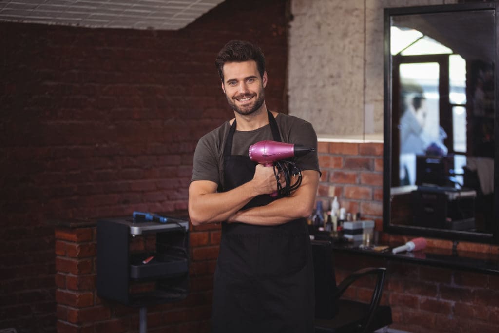 Hairdresser holding a hairdryer