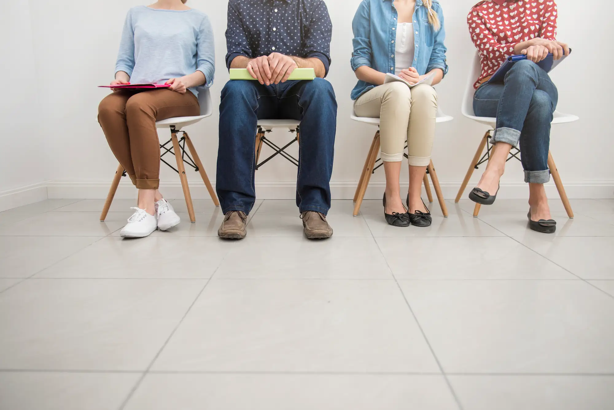 People sitting on chairs in a row