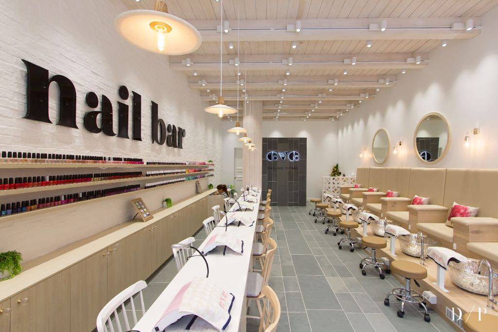 wide view of nail bar with nail salon chairs