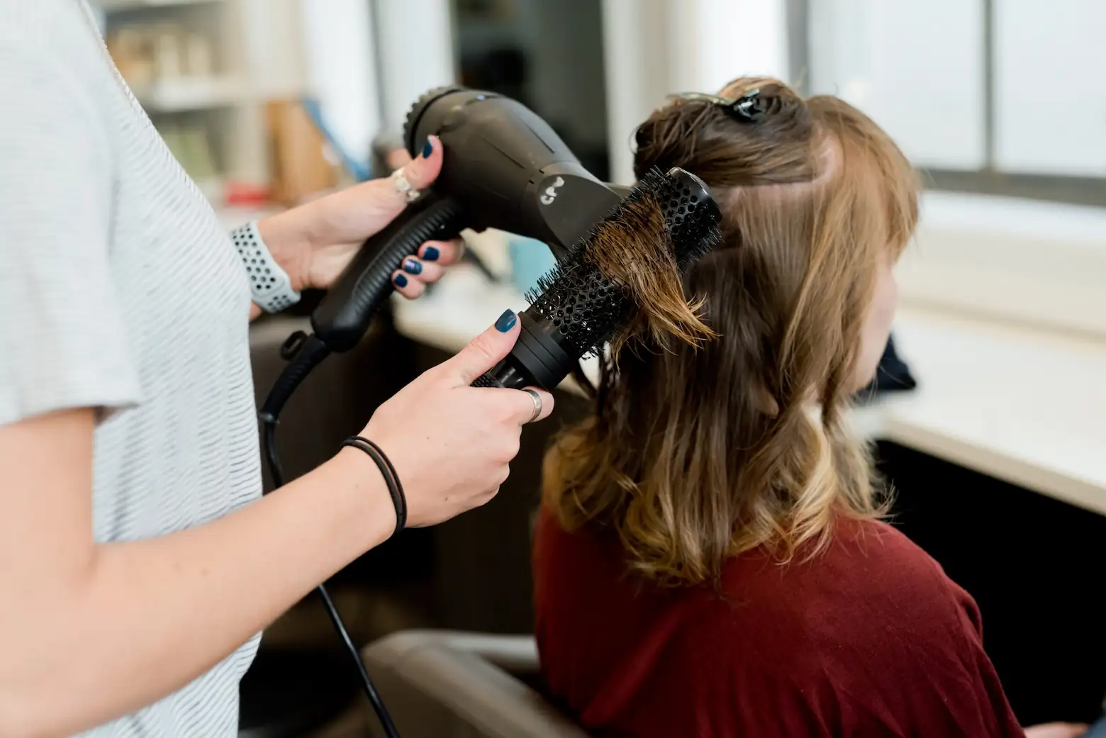 person blowdrying someone's hair