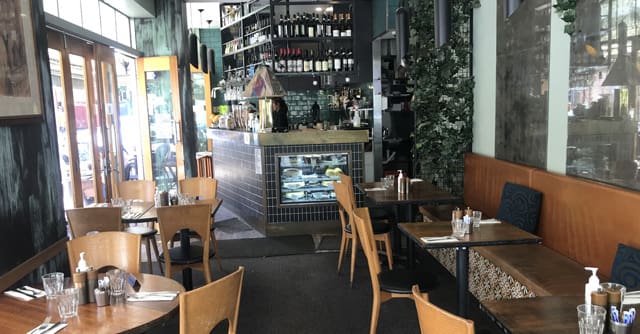 Kirribilli Village Cafe store with tables and chairs