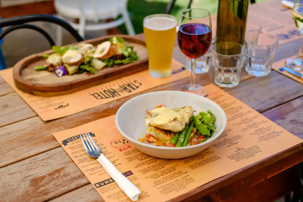 table with plates of food and drinks