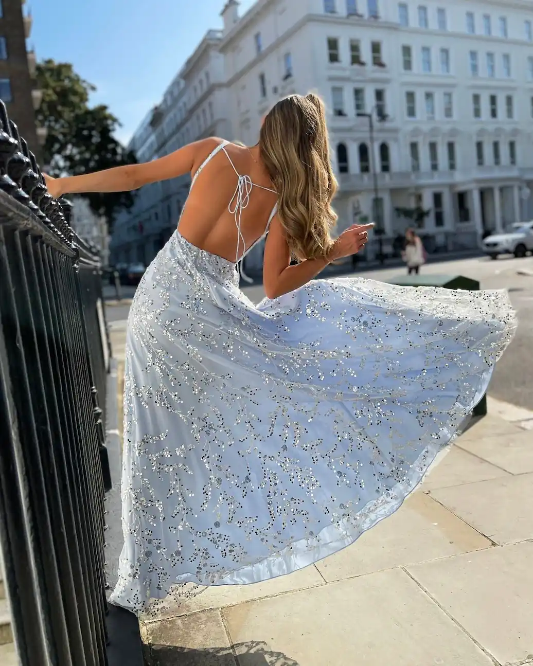 person in blue dress swinging on gate