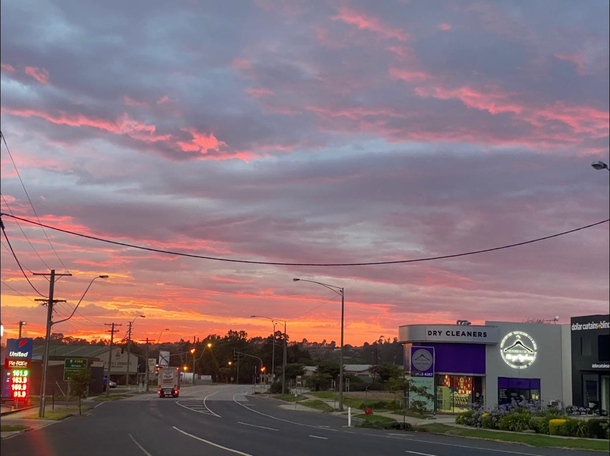 Pink sky with Dry Cleaner out front