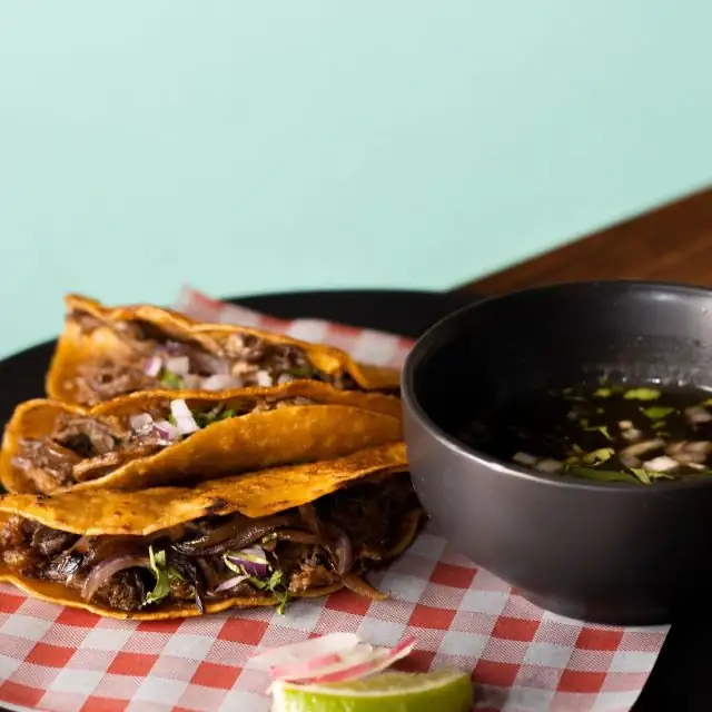 Plate of tacos and dipping sauce